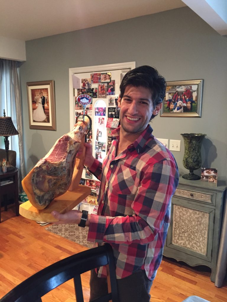 Vincent holding a cured ham